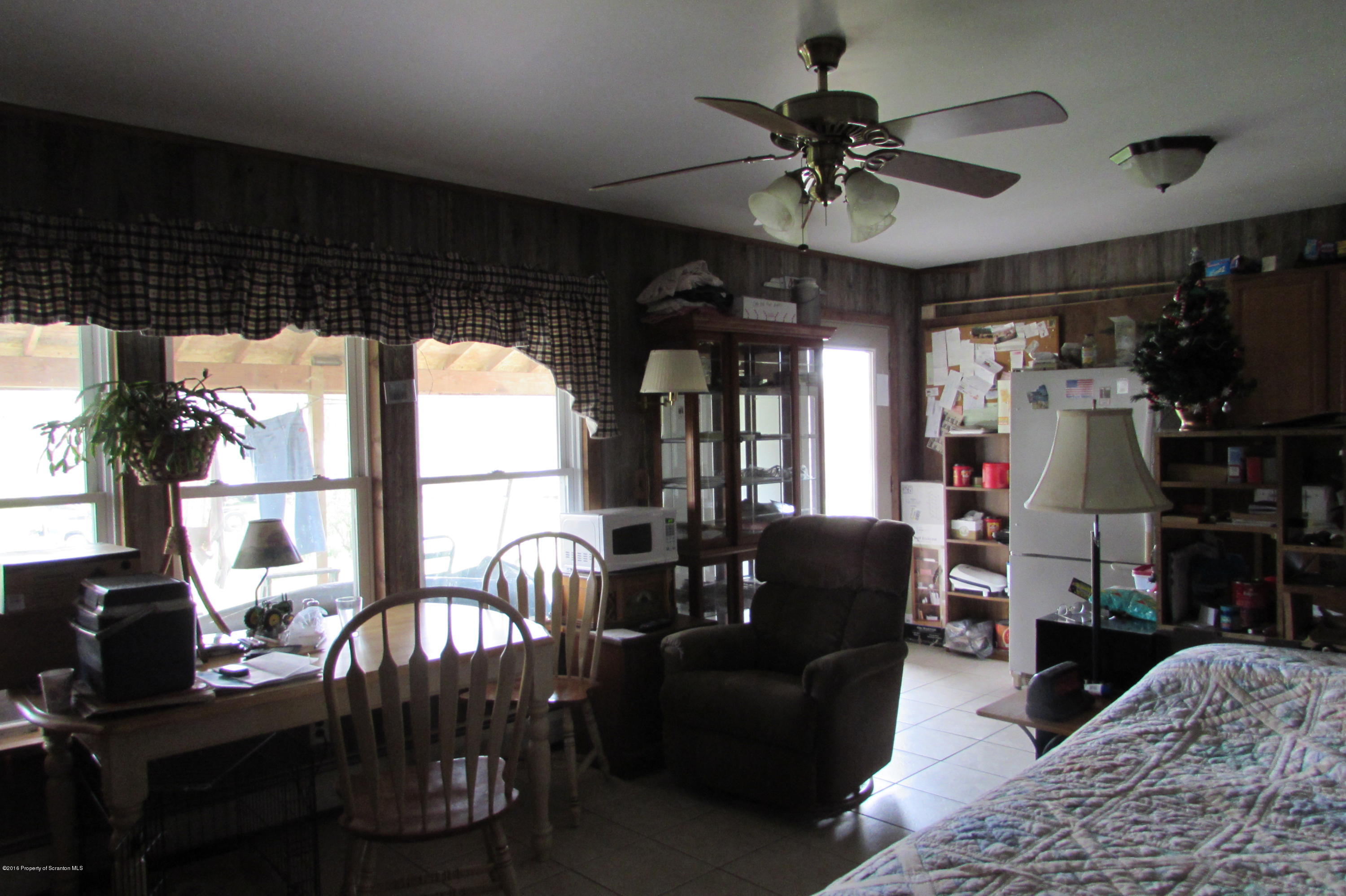 637 Craig Hill Road Meshoppen, PA 18630 - Photo 6 of 22 a living room with furniture a flat screen tv and a large window