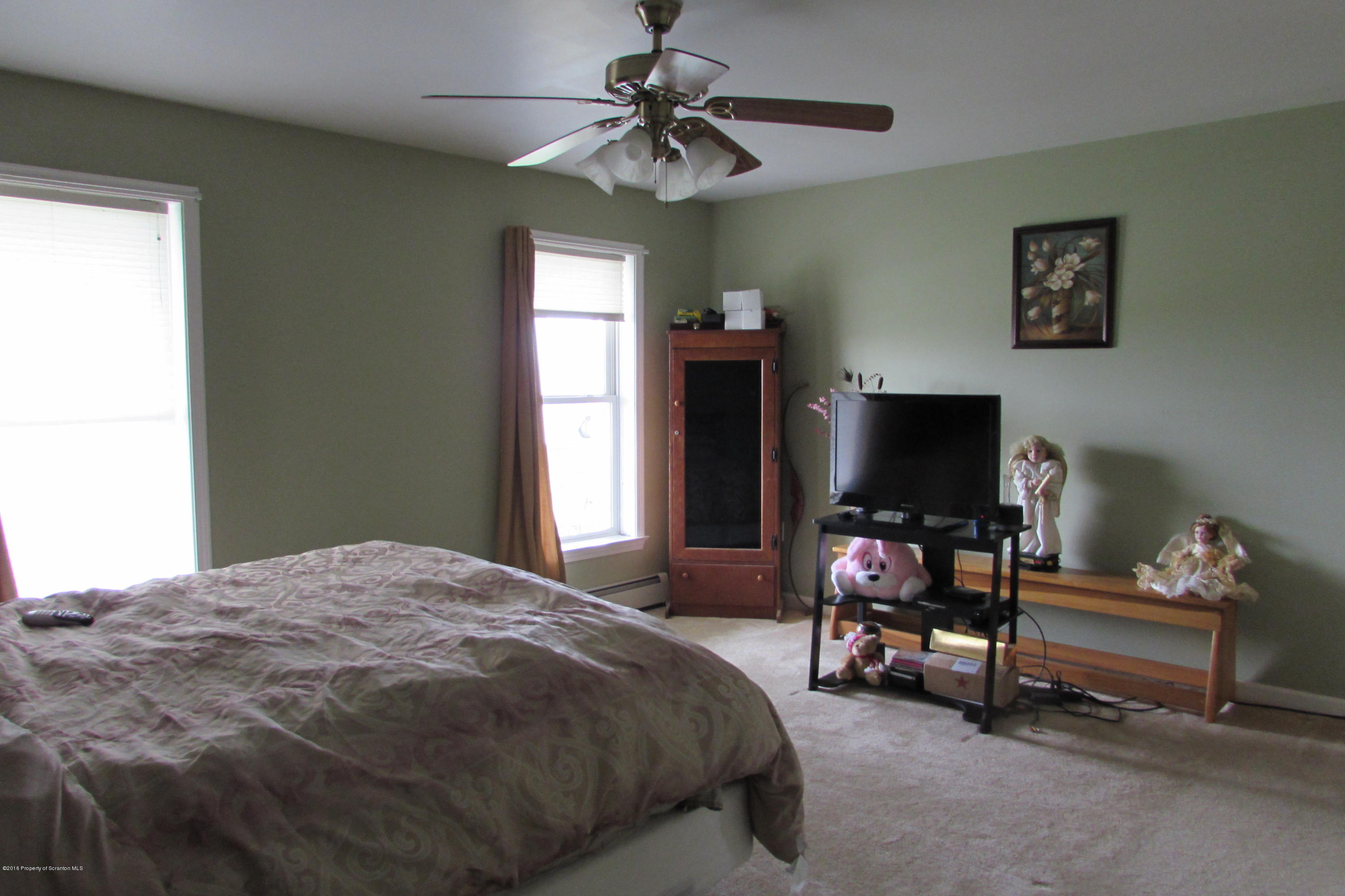 637 Craig Hill Road Meshoppen, PA 18630 - Photo 7 of 22 a bedroom with a bed and a flat screen tv