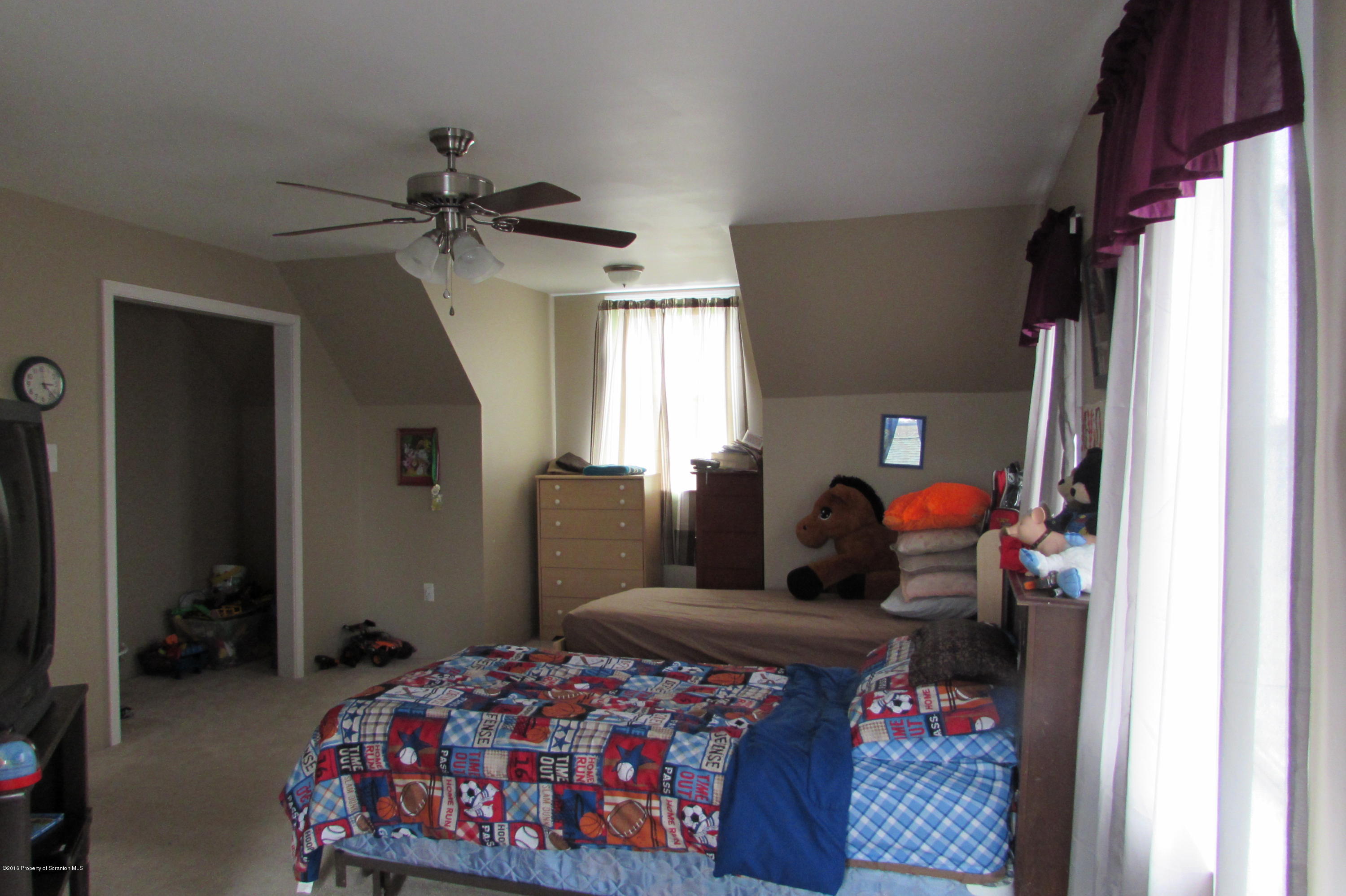 637 Craig Hill Road Meshoppen, PA 18630 - Photo 8 of 22 a bedroom with a bed closet and a window