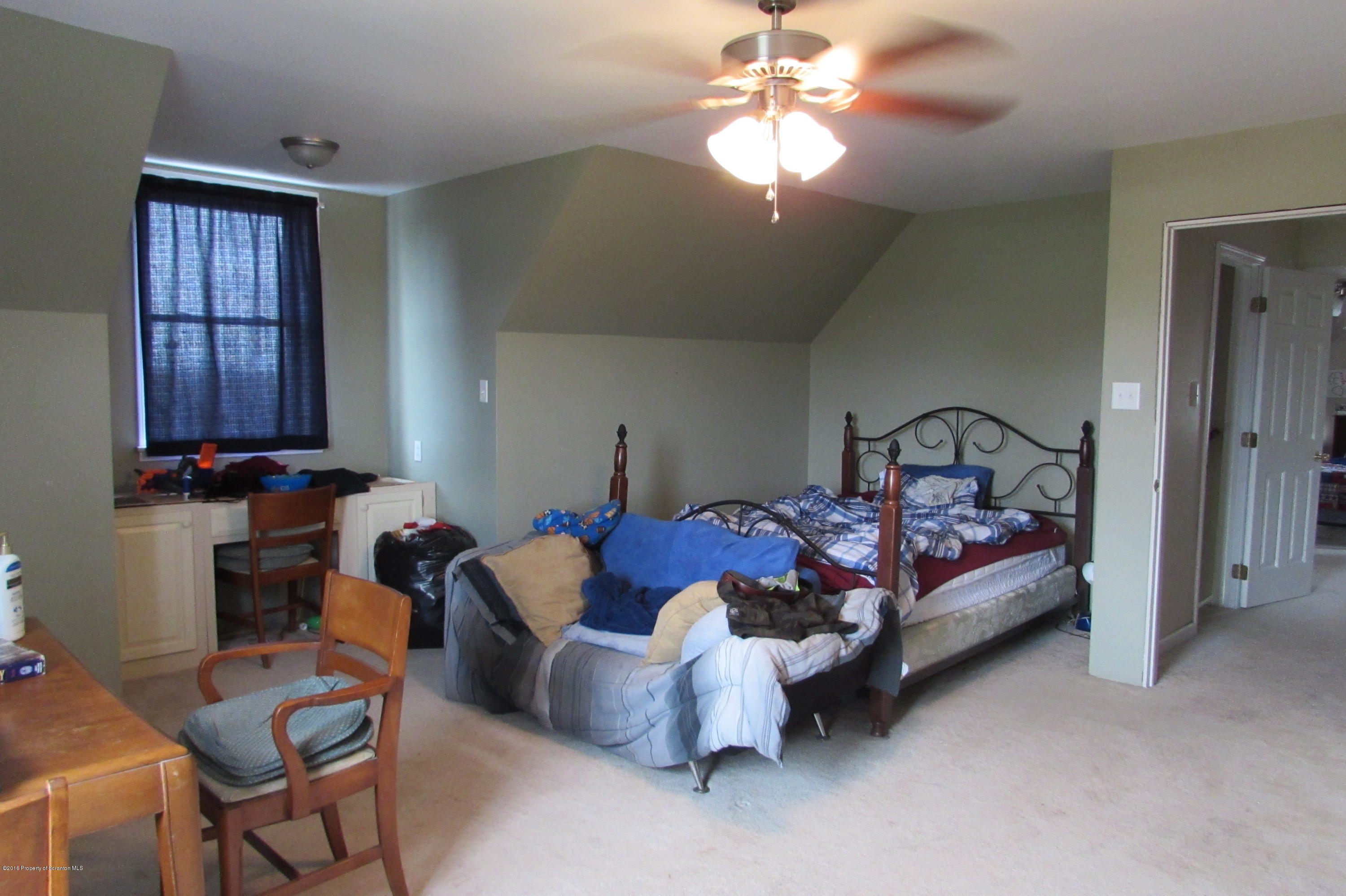 637 Craig Hill Road Meshoppen, PA 18630 - Photo 9 of 22 a bedroom with furniture and a chandelier