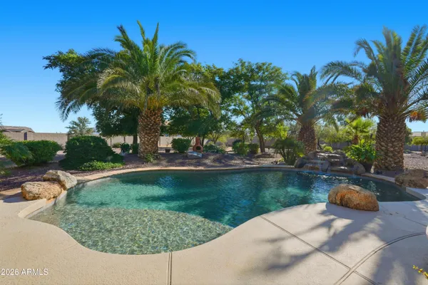 a view of a swimming pool and lounge chairs