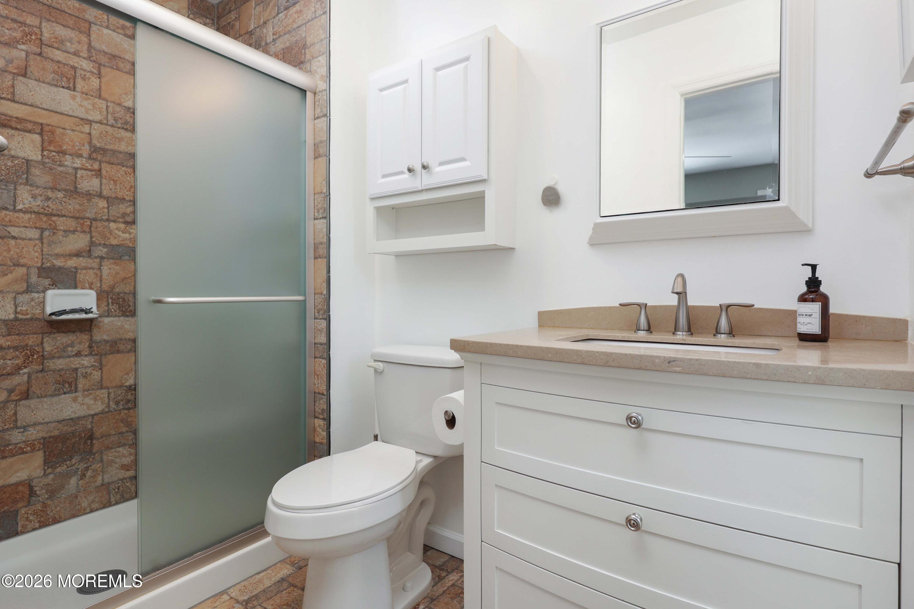 27 Jennifer Drive Howell, NJ 07731 - Photo 16 of 27 a bathroom with a sink a toilet and shower