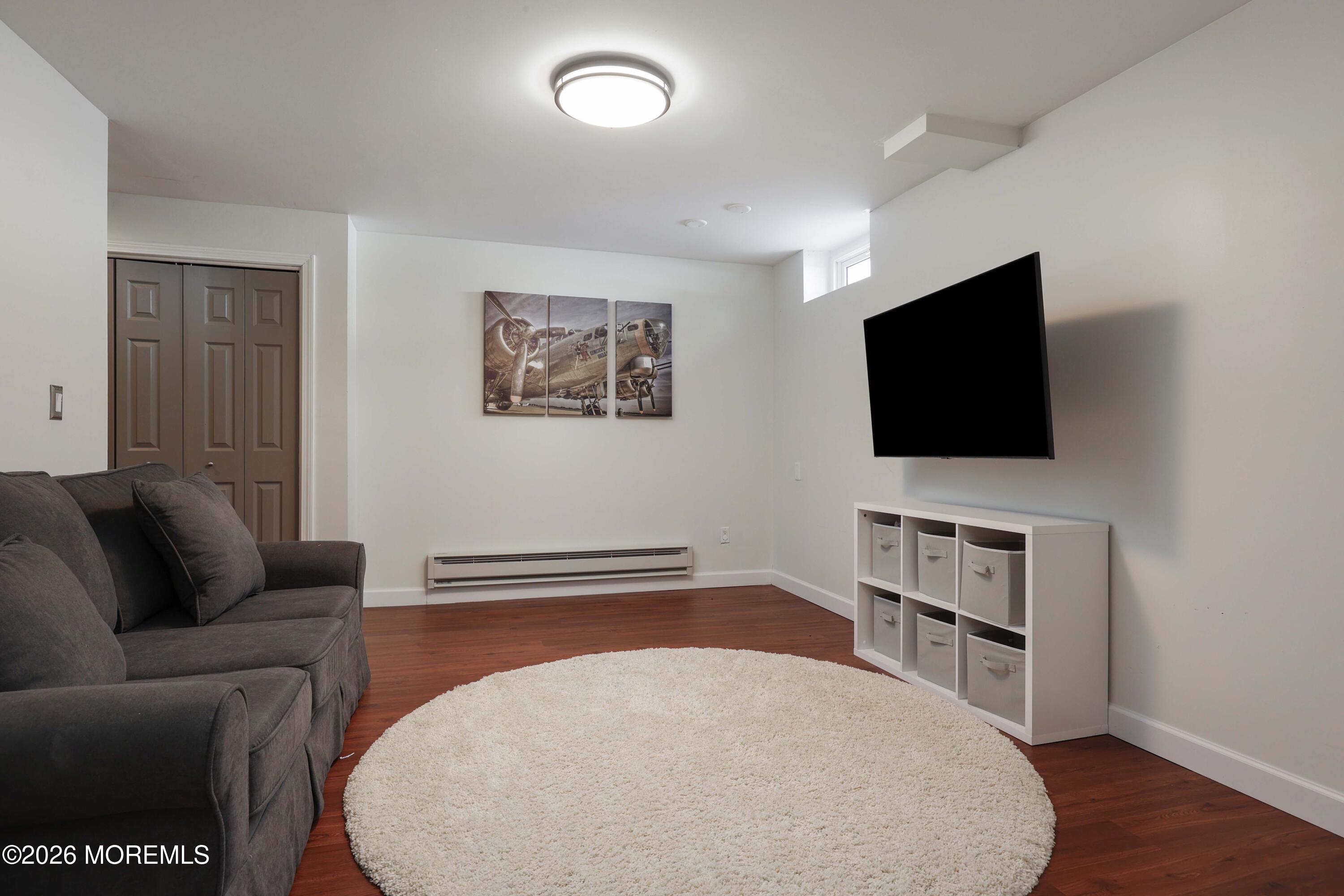 27 Jennifer Drive Howell, NJ 07731 - Photo 21 of 27 a living room with furniture and a flat screen tv