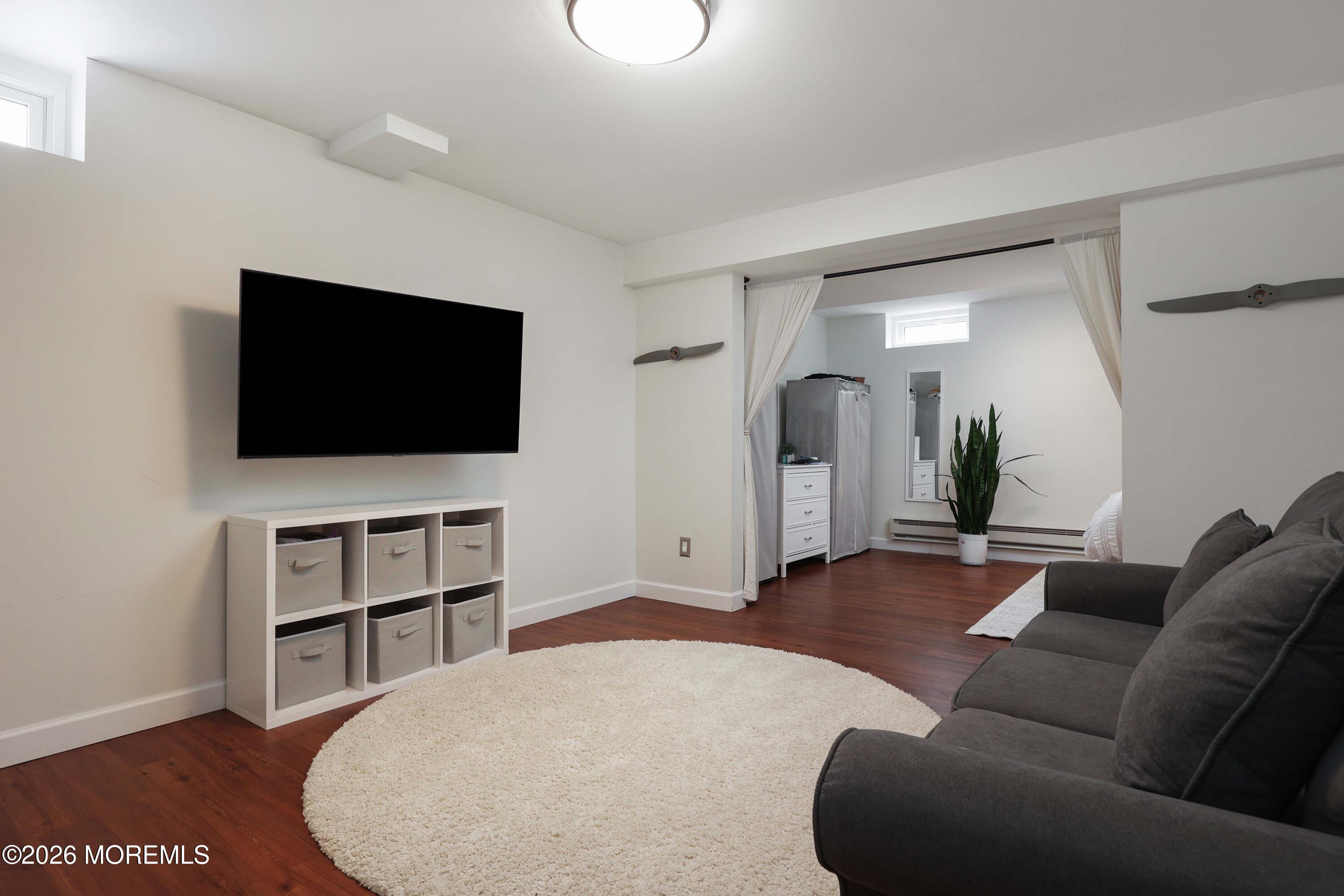 27 Jennifer Drive Howell, NJ 07731 - Photo 22 of 27 a living room with furniture and a flat screen tv