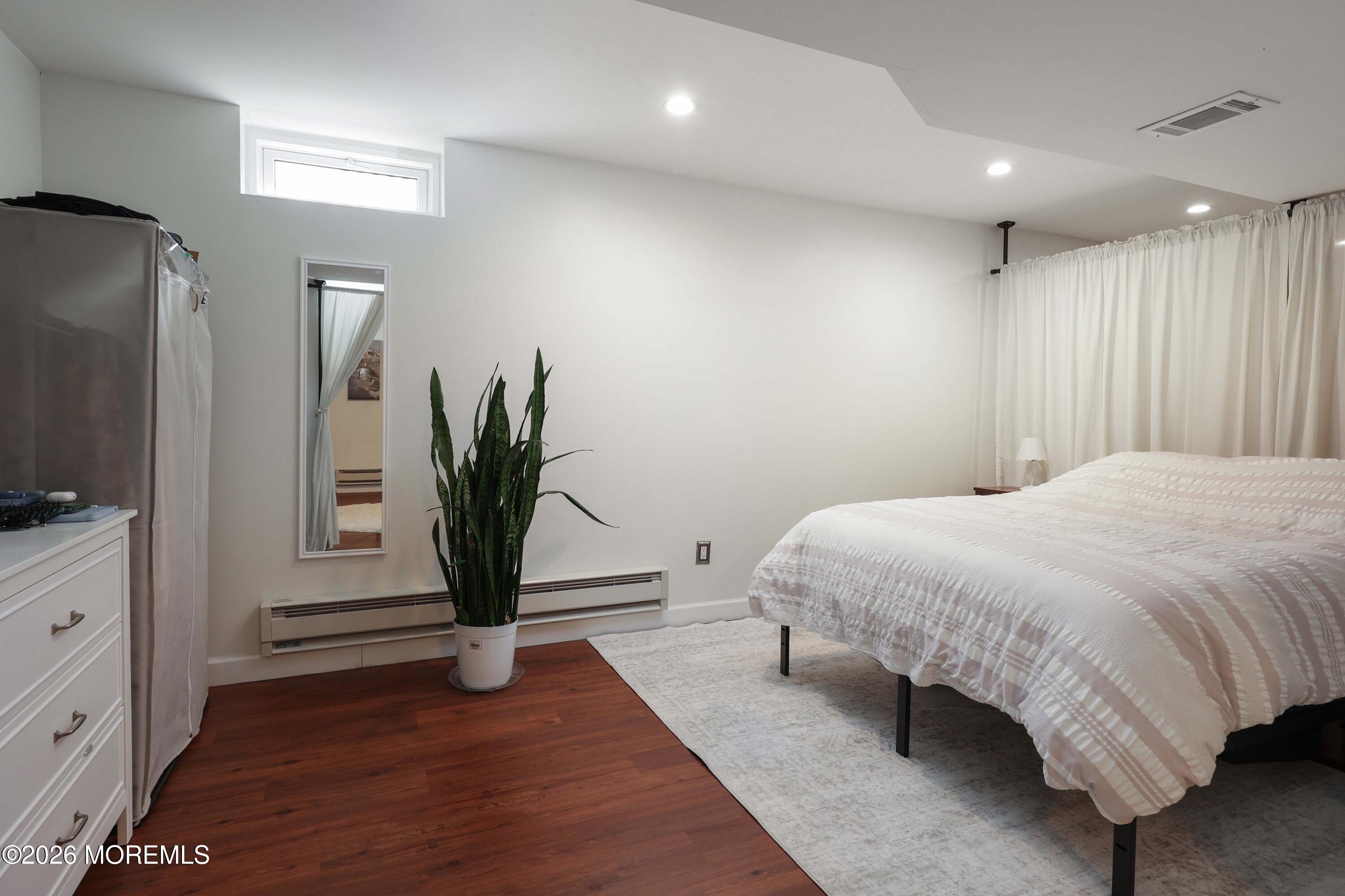 27 Jennifer Drive Howell, NJ 07731 - Photo 23 of 27 a spacious bedroom with a bed and a flat screen tv