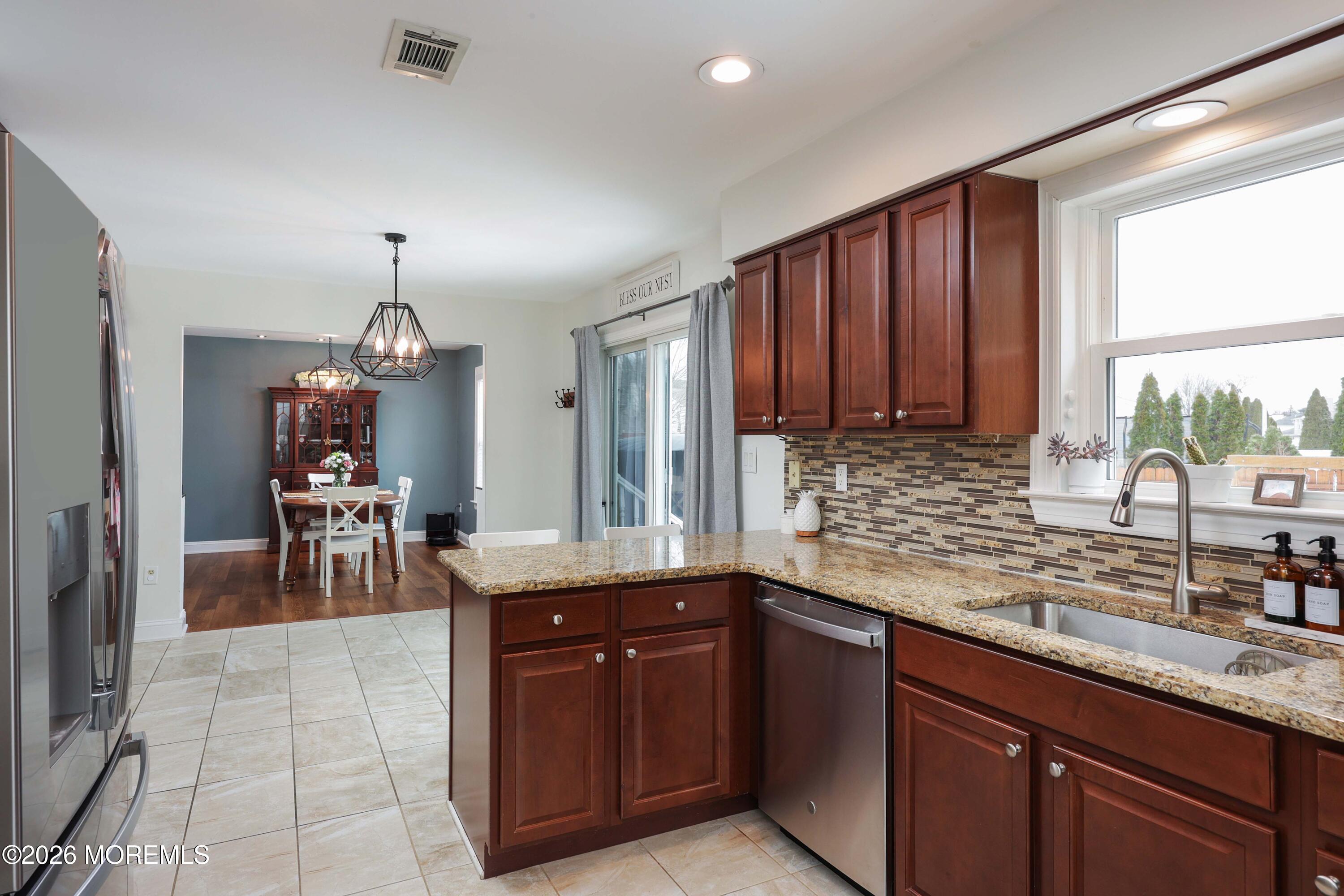 27 Jennifer Drive Howell, NJ 07731 - Photo 10 of 27 a kitchen with granite countertop a sink counter top space appliances and cabinets