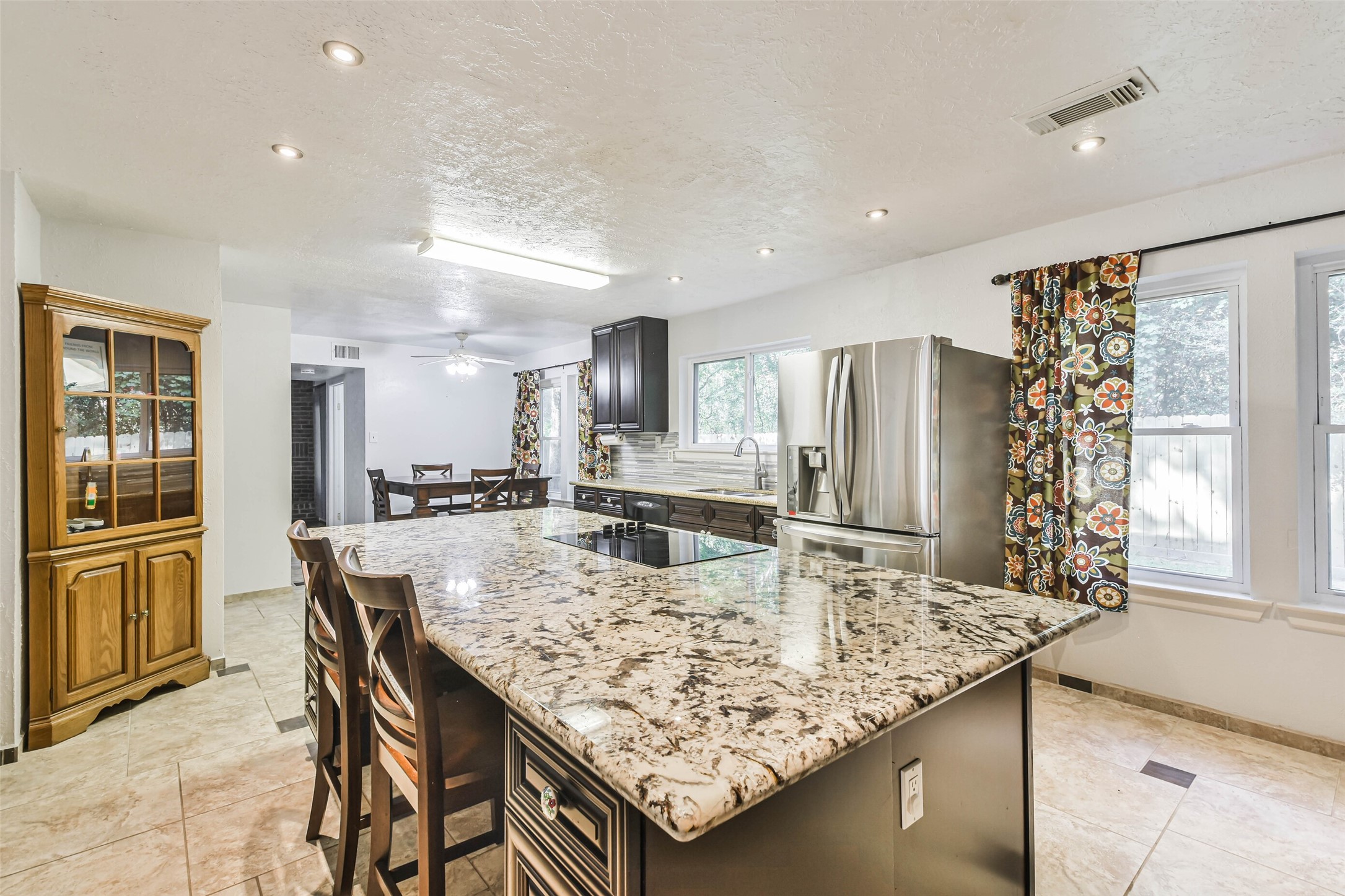 12 Coralberry Road Spring, TX 77381 - Photo 20 of 45 a kitchen with stainless steel appliances granite countertop a kitchen island a cabinetry and refrigerator