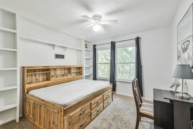 a bedroom with a bed and a table in it