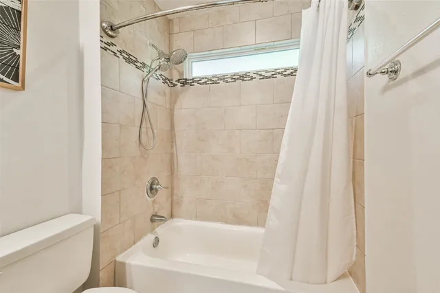 a bathroom with a shower and a bath tub