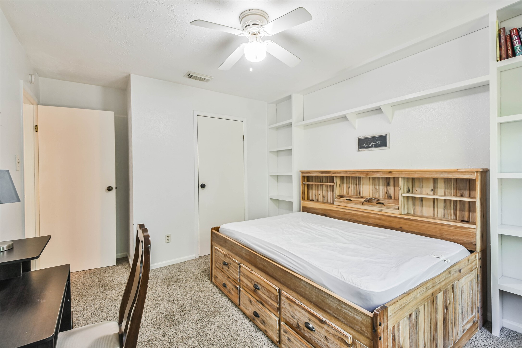 12 Coralberry Road Spring, TX 77381 - Photo 38 of 45 a bedroom with a bed and a chandelier