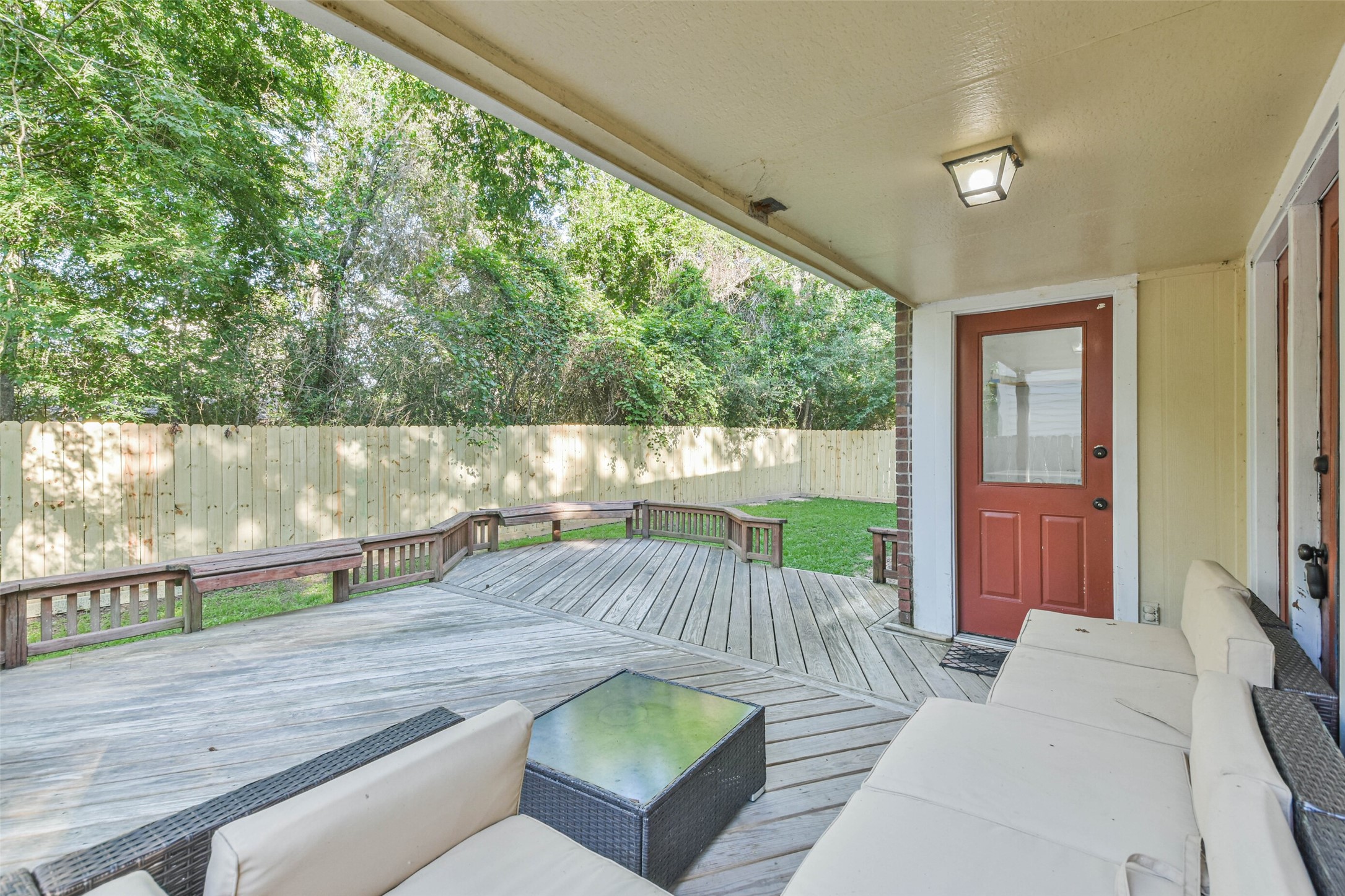 12 Coralberry Road Spring, TX 77381 - Photo 45 of 45 a view of a patio with couches table and chairs under an umbrella with wooden floor