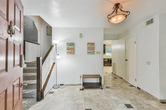 a view of a livingroom with furniture and staircase