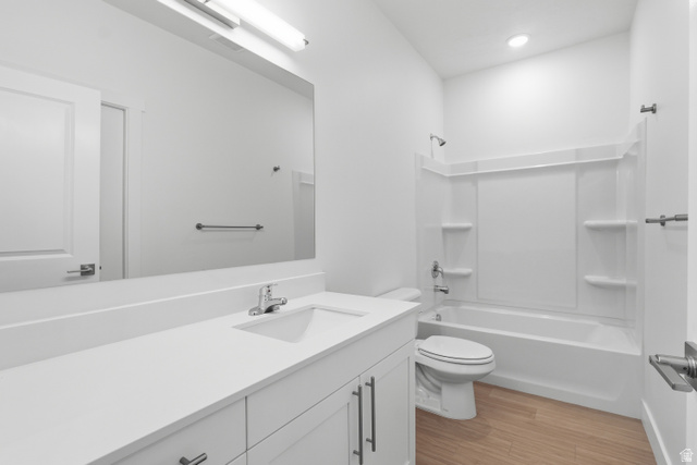2085 North Main Street, Unit 301 Sunset, UT 84015 - Photo 10 of 20 Bathroom with vanity, light wood-style flooring, and tub / shower combination