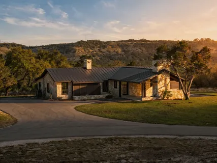 an aerial view of residential houses with outdoor space and trees