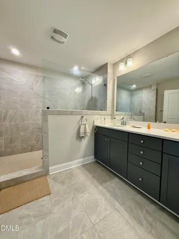 a bathroom with a sink mirror and a bath tub
