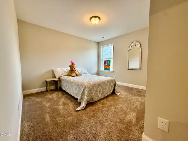 a bed room with a bed and a window