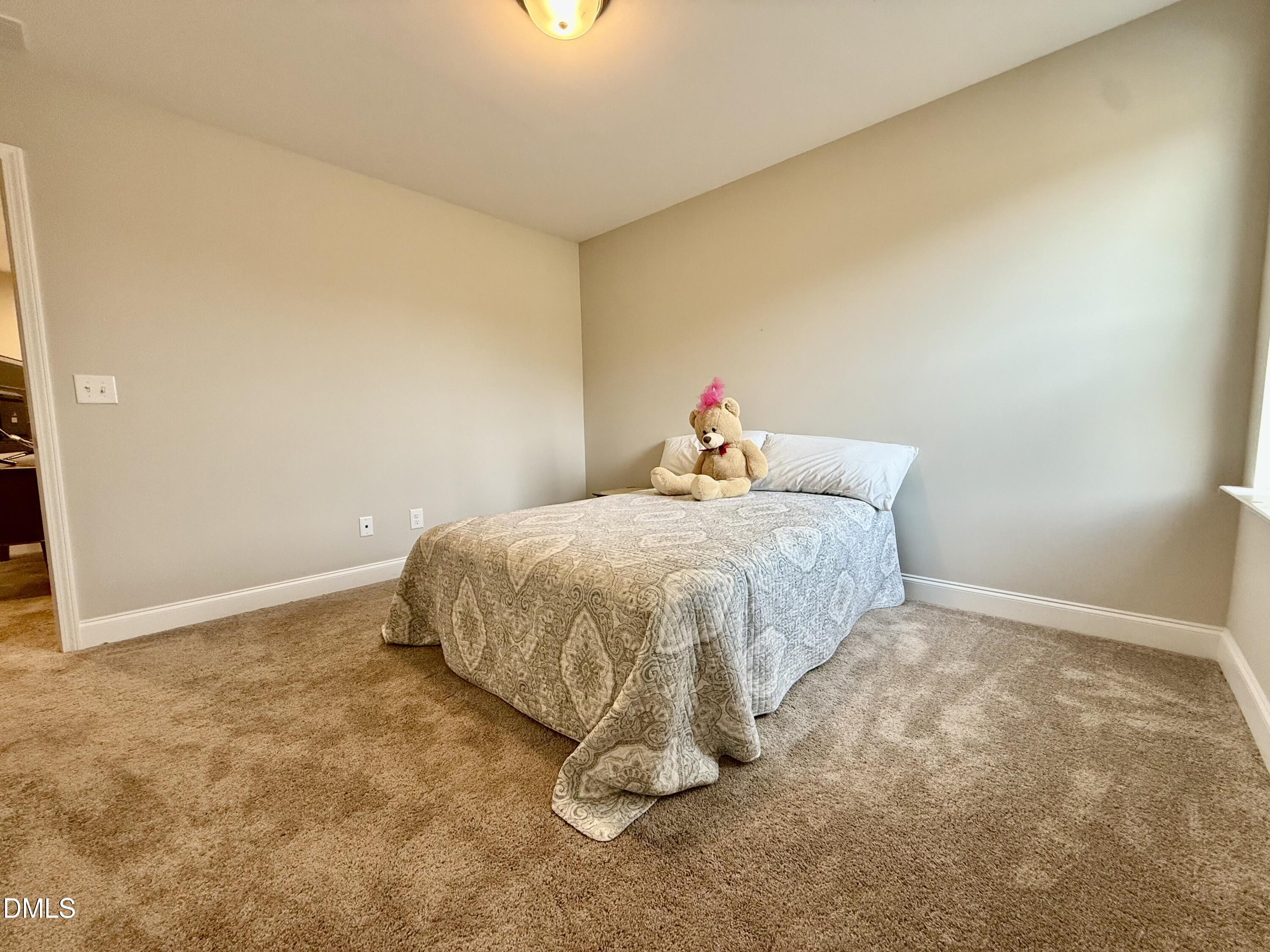 254 Deardom Way Chapel Hill, NC 27516 - Photo 17 of 21 a bed sitting in a bedroom next to a window