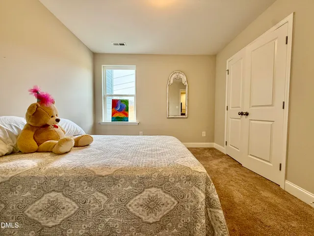 a bed room with a bed and a window