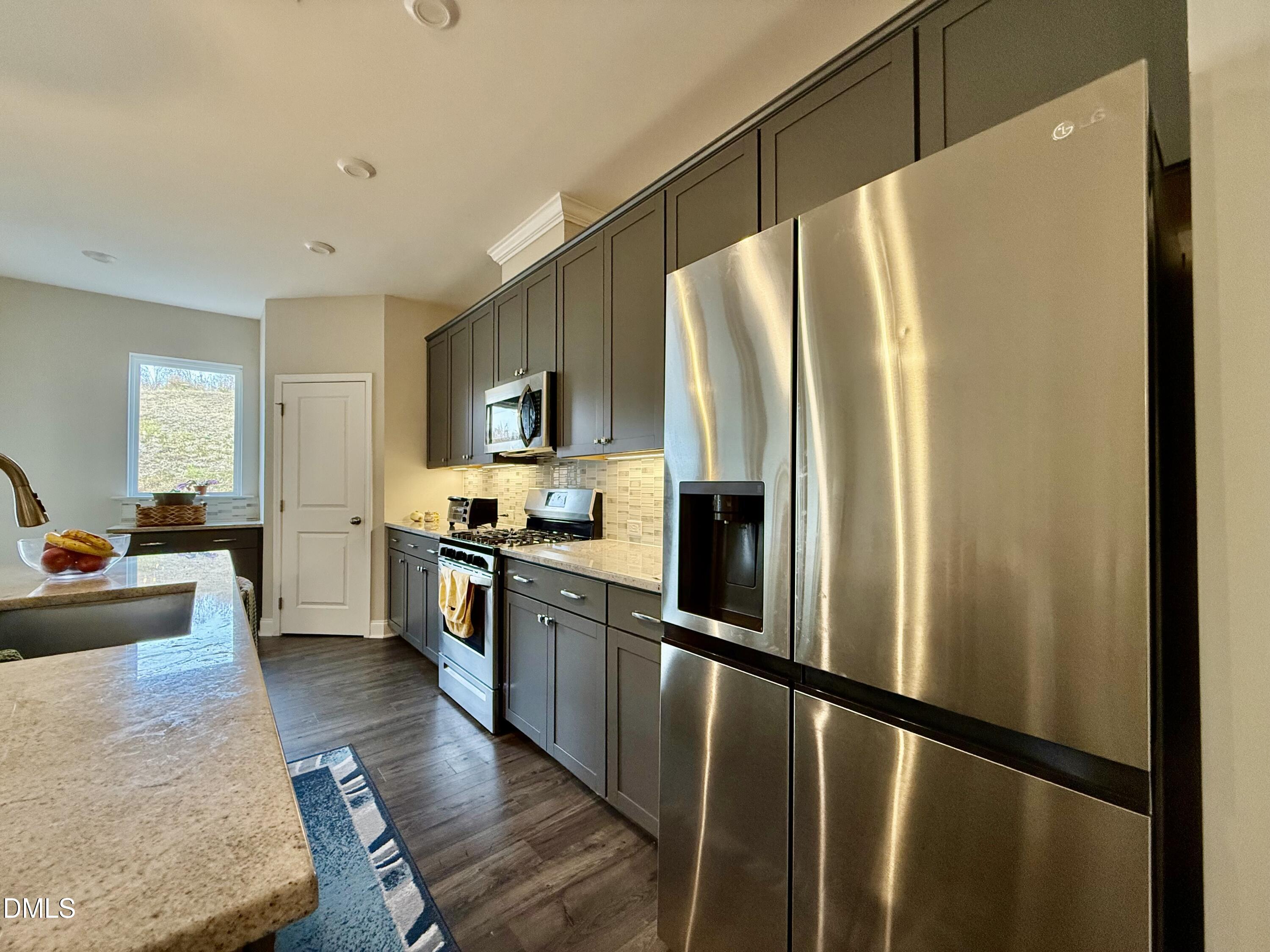 254 Deardom Way Chapel Hill, NC 27516 - Photo 5 of 21 a kitchen with stainless steel appliances a refrigerator and a stove