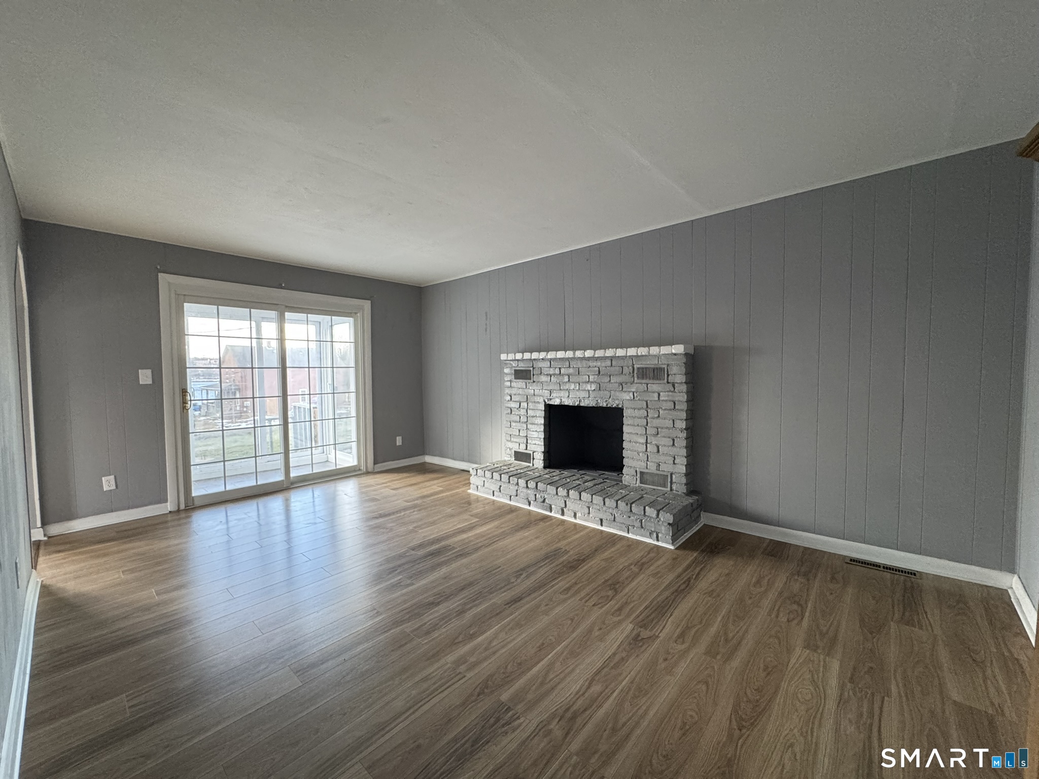 310 Lestertown Road Groton, CT 06340 - Photo 16 of 31 a view of empty room with wooden floor and fireplace