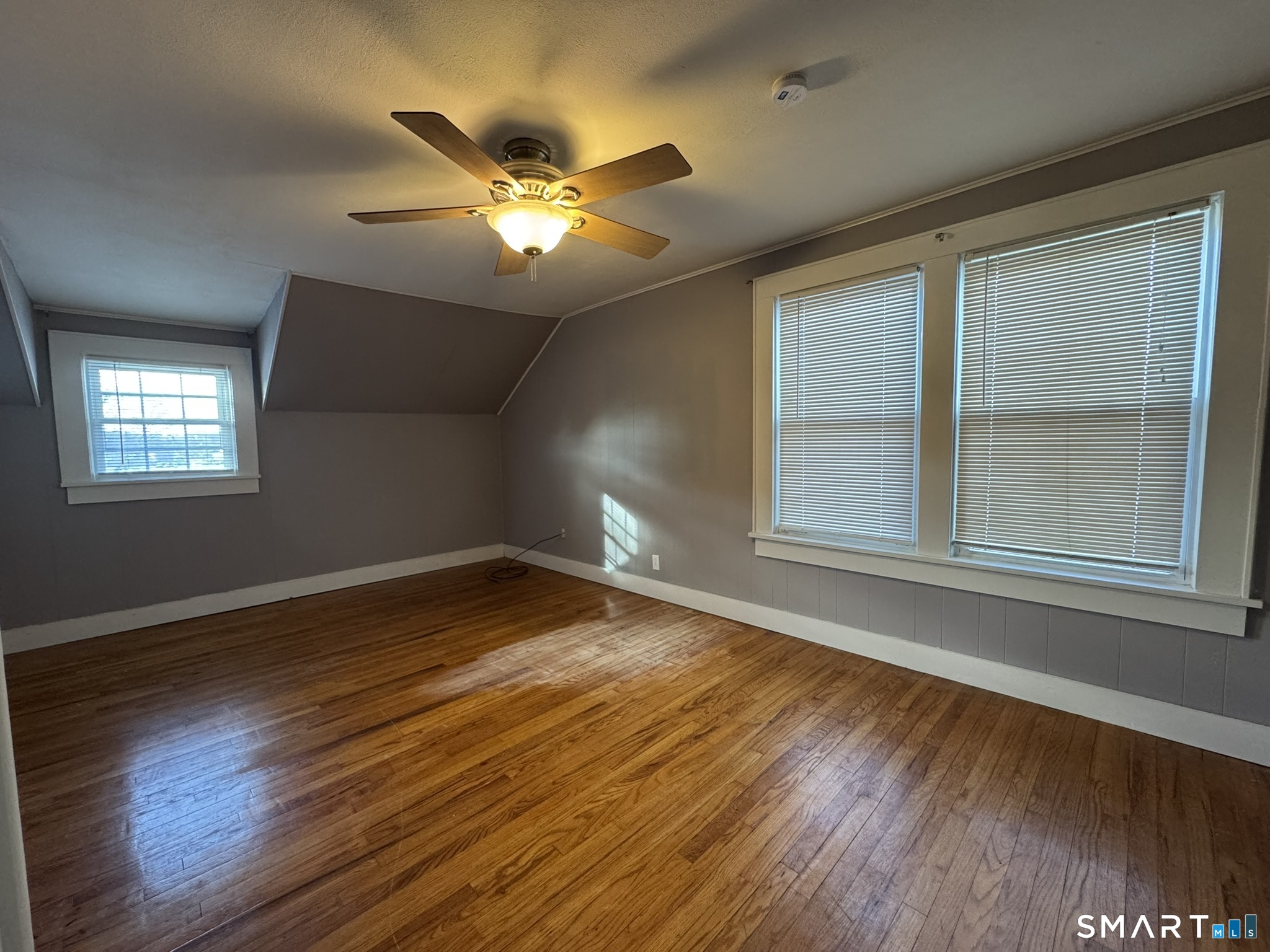 310 Lestertown Road Groton, CT 06340 - Photo 17 of 31 a view of an empty room with wooden floor and a window