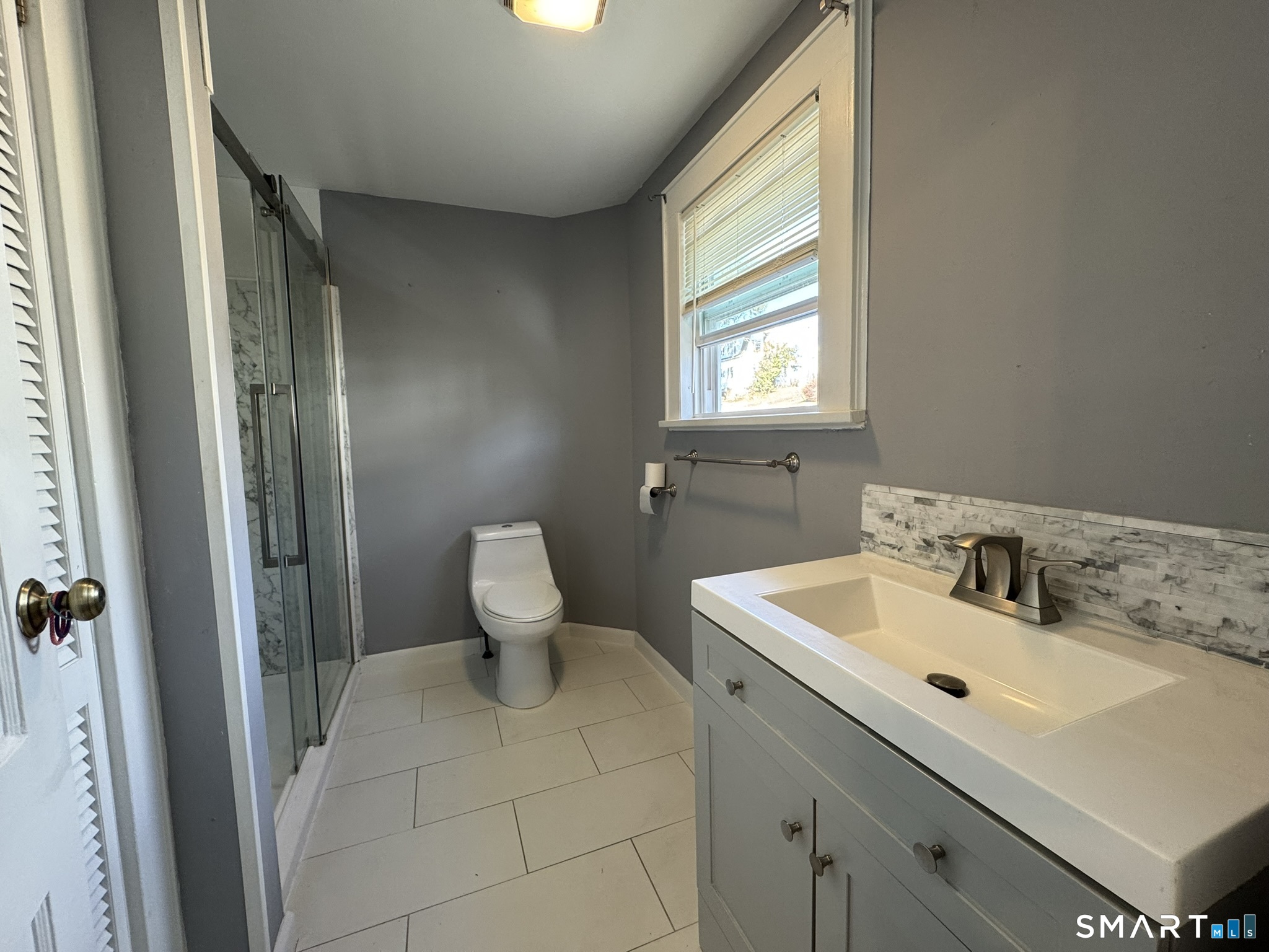 310 Lestertown Road Groton, CT 06340 - Photo 21 of 31 a bathroom with a sink mirror toilet and next to a window
