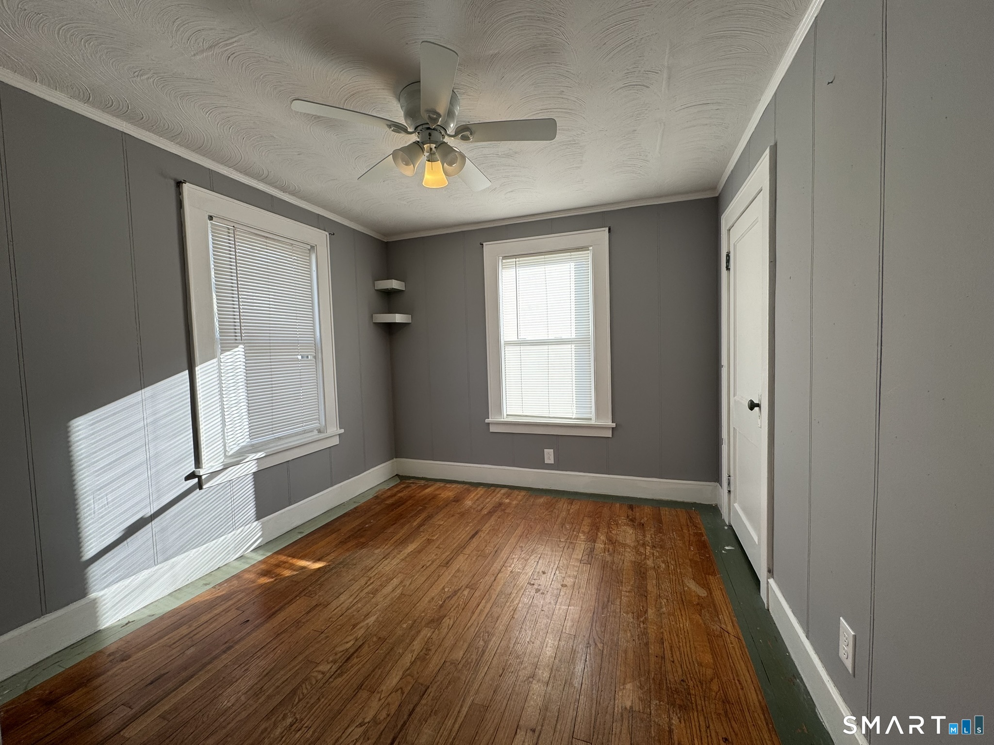 310 Lestertown Road Groton, CT 06340 - Photo 22 of 31 a view of an empty room with wooden floor and a window