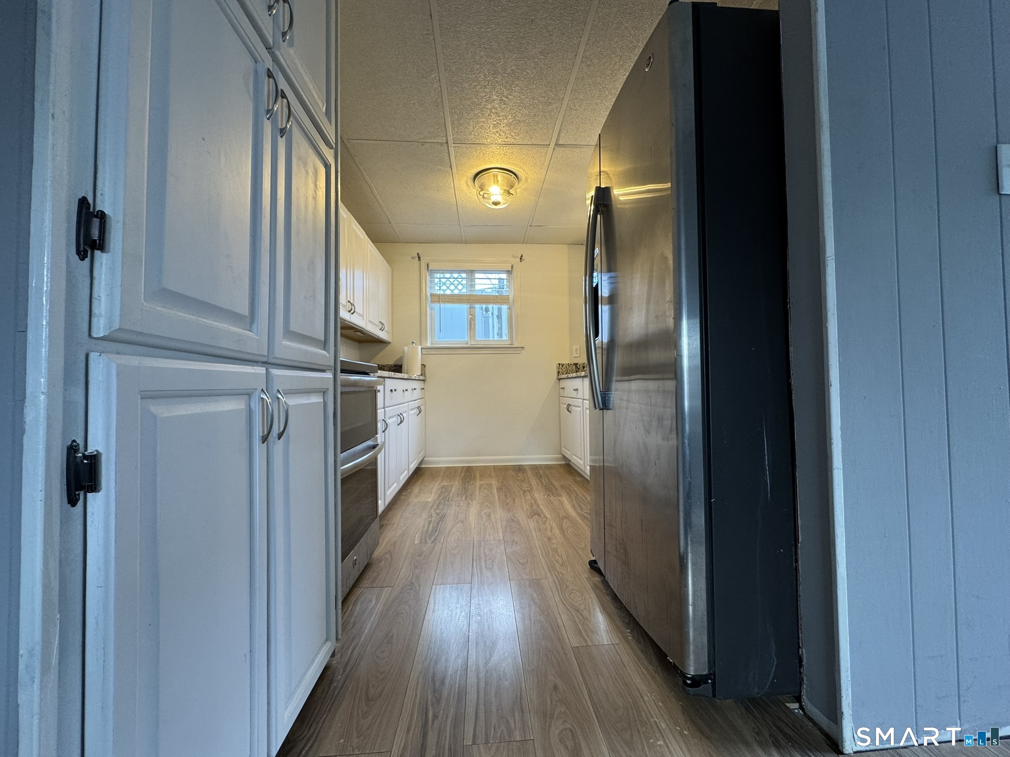 310 Lestertown Road Groton, CT 06340 - Photo 3 of 31 a view of a hallway with wooden floor