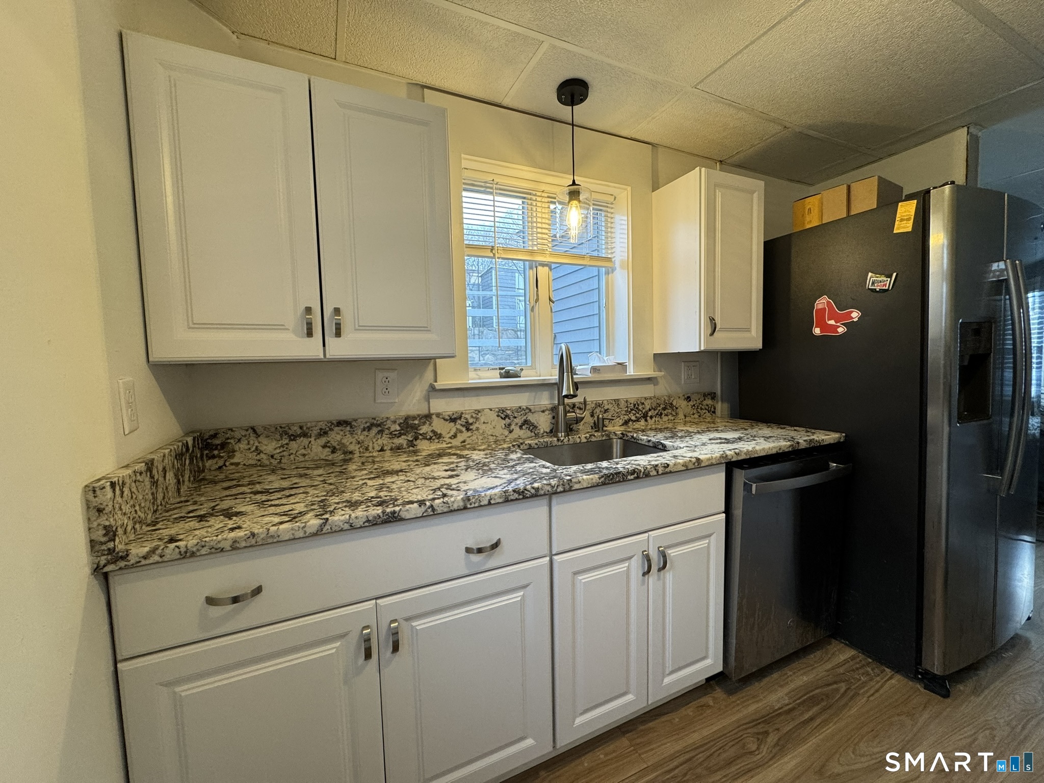 310 Lestertown Road Groton, CT 06340 - Photo 5 of 31 a kitchen with granite countertop a sink cabinets and stainless steel appliances