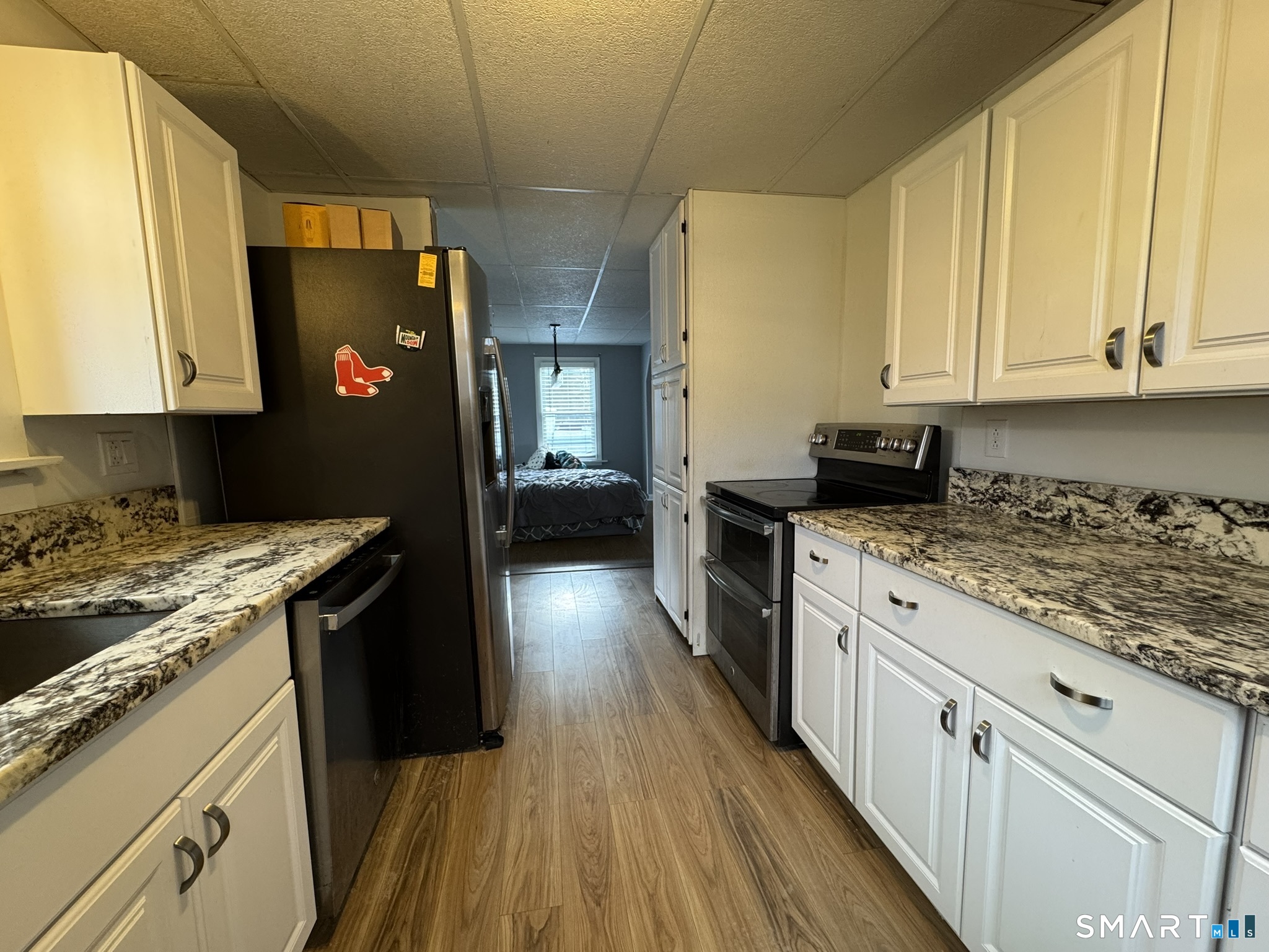 310 Lestertown Road Groton, CT 06340 - Photo 6 of 31 a kitchen with granite countertop a sink stove and refrigerator
