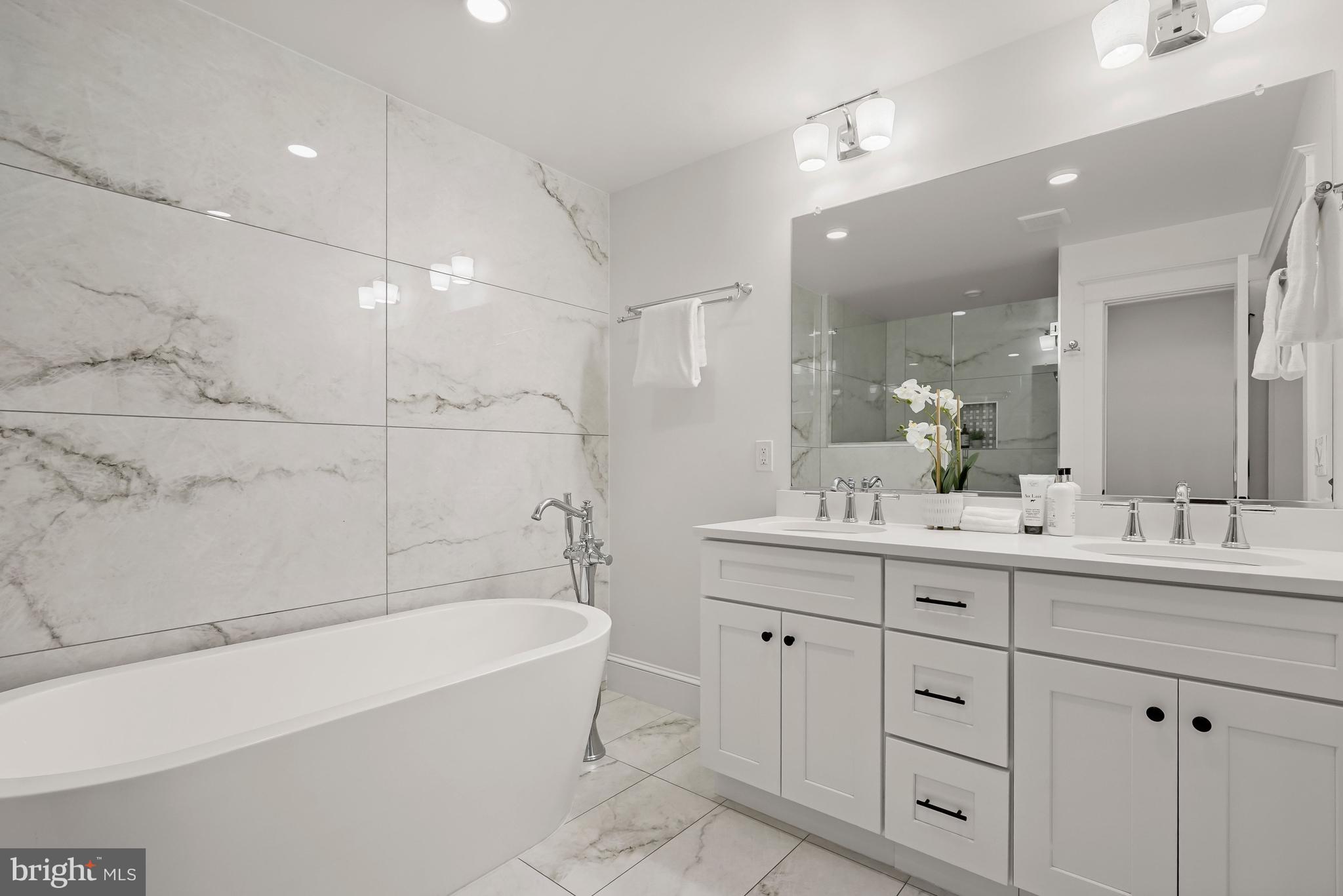 3719 R Street Northwest Washington, DC 20007 - Photo 18 of 44 a bathroom with a bathtub a double vanity sink and mirror
