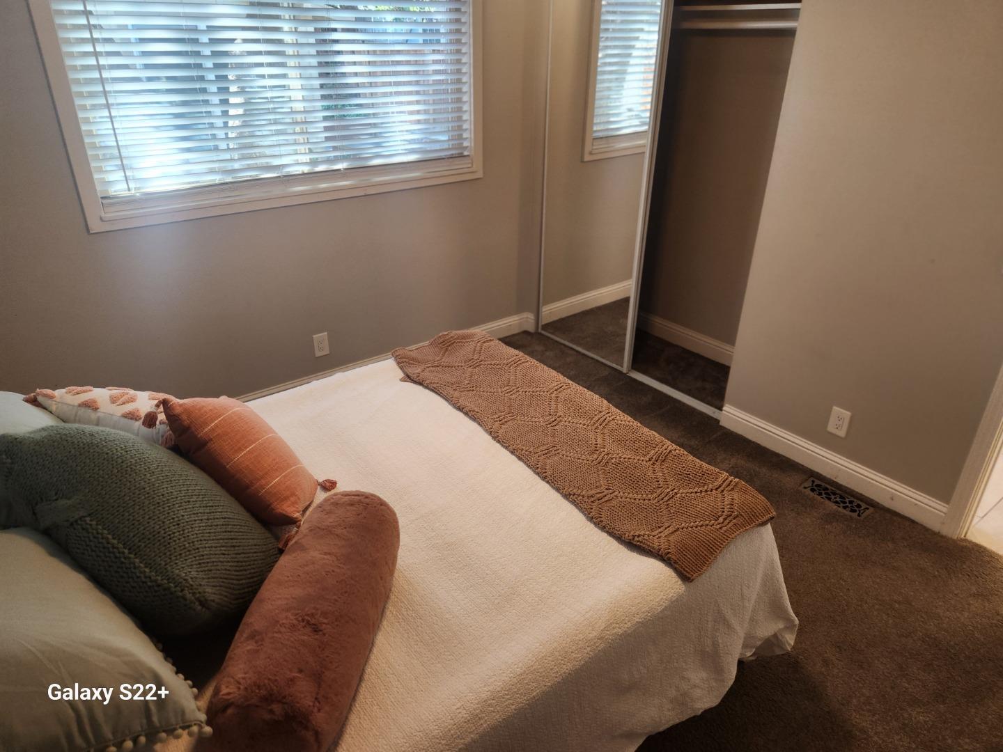 1186 Third Street Monterey, CA 93940 - Photo 16 of 24 a bed sitting in a bedroom next to a window