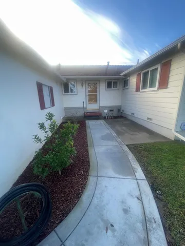a front view of a house with garden