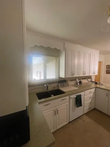 a kitchen with a sink and cabinets