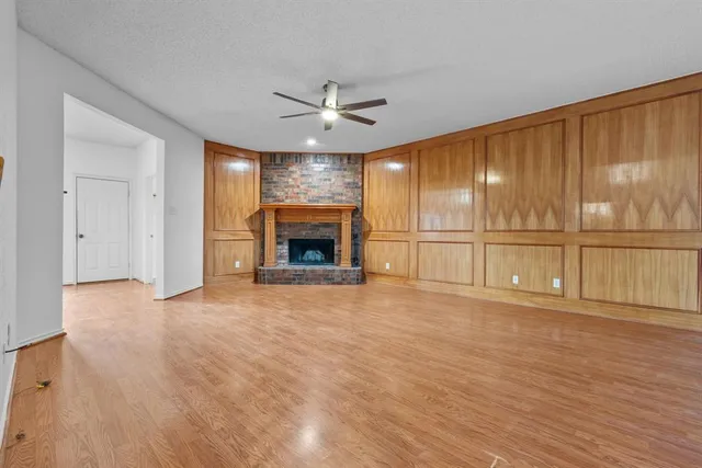 wooden floor fireplace and natural light in room
