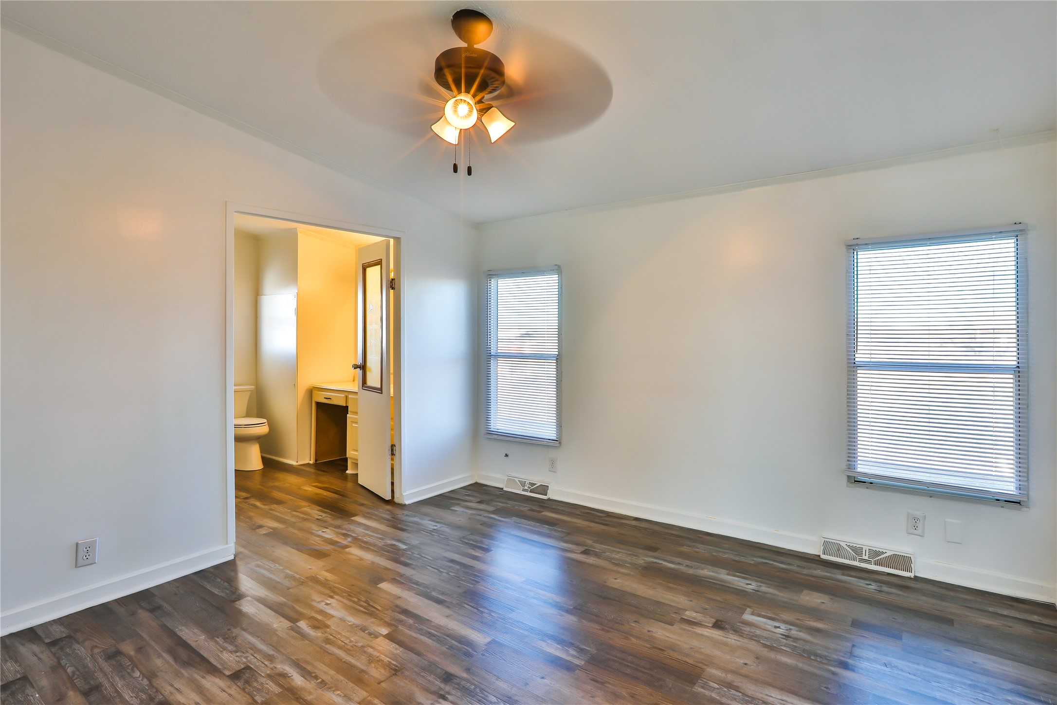 172 Kid Ranch Lane San Marcos, TX 78666 - Photo 19 of 29 Unfurnished bedroom with dark wood finished floors, ensuite bath, and ceiling fan