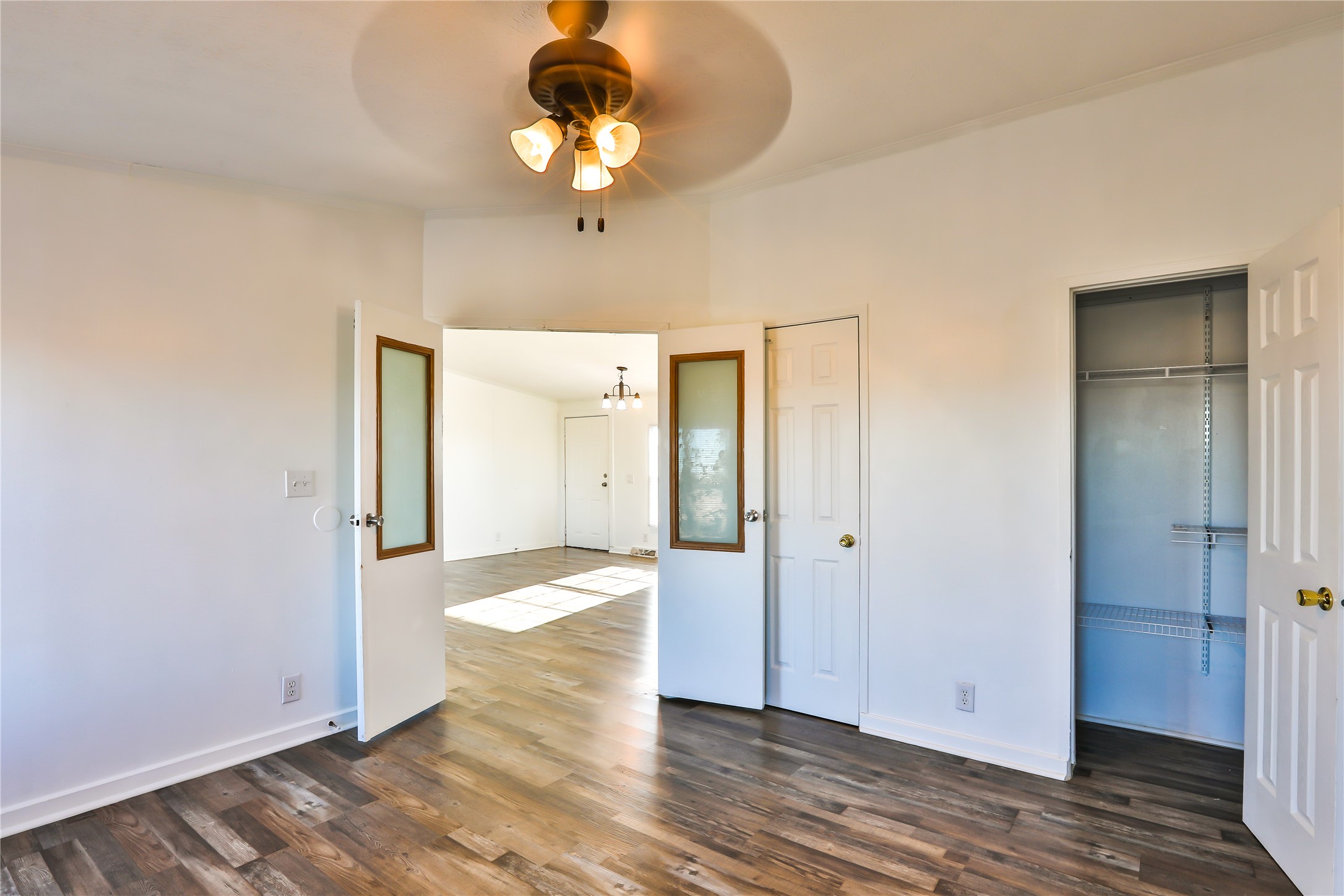 172 Kid Ranch Lane San Marcos, TX 78666 - Photo 21 of 29 Unfurnished bedroom featuring a chandelier, dark wood-style flooring, a ceiling fan, and lofted ceiling