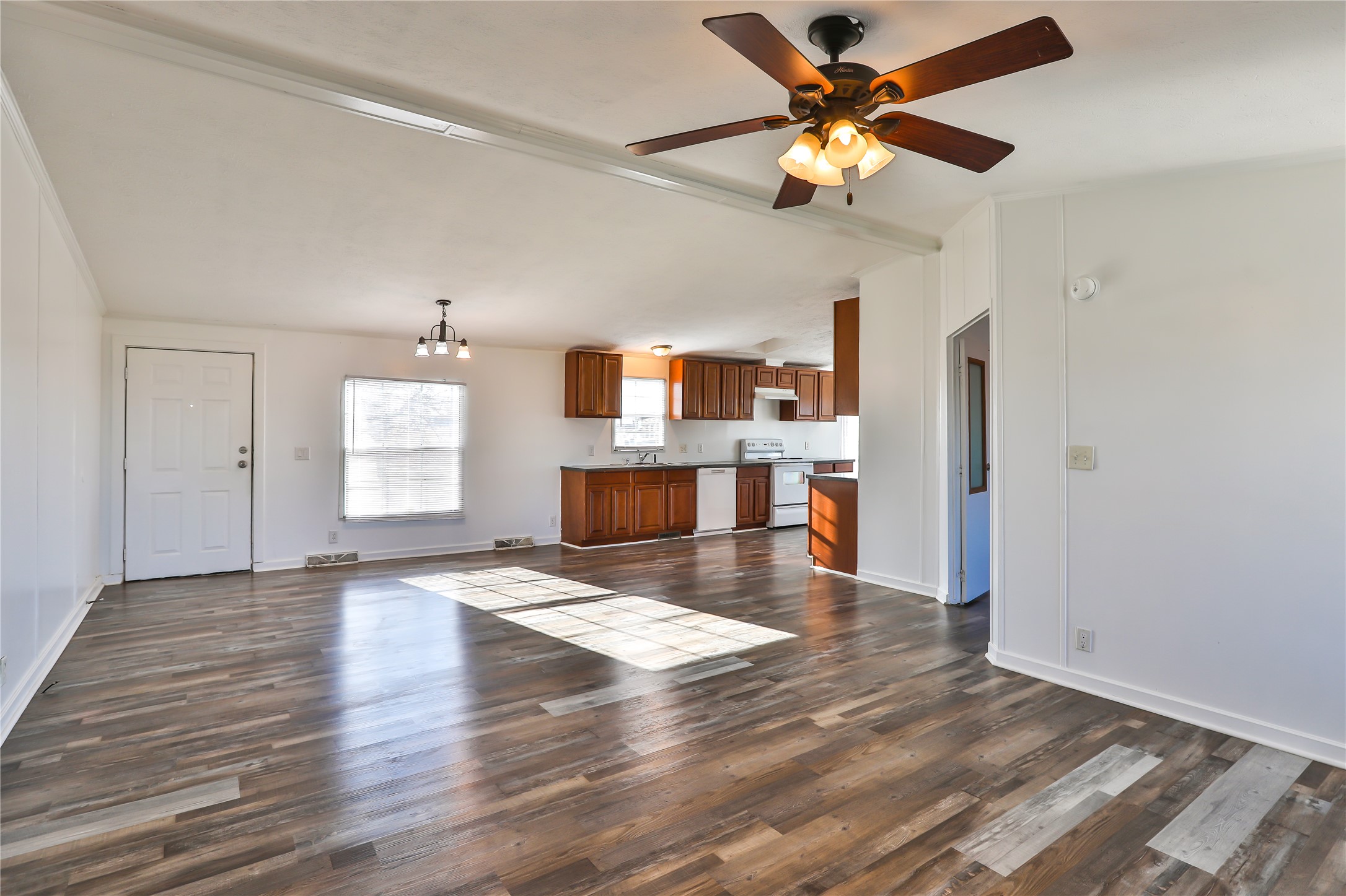 172 Kid Ranch Lane San Marcos, TX 78666 - Photo 4 of 29 Unfurnished living room featuring hanging lights, dark wood finished floors, a ceiling fan, and lofted ceiling