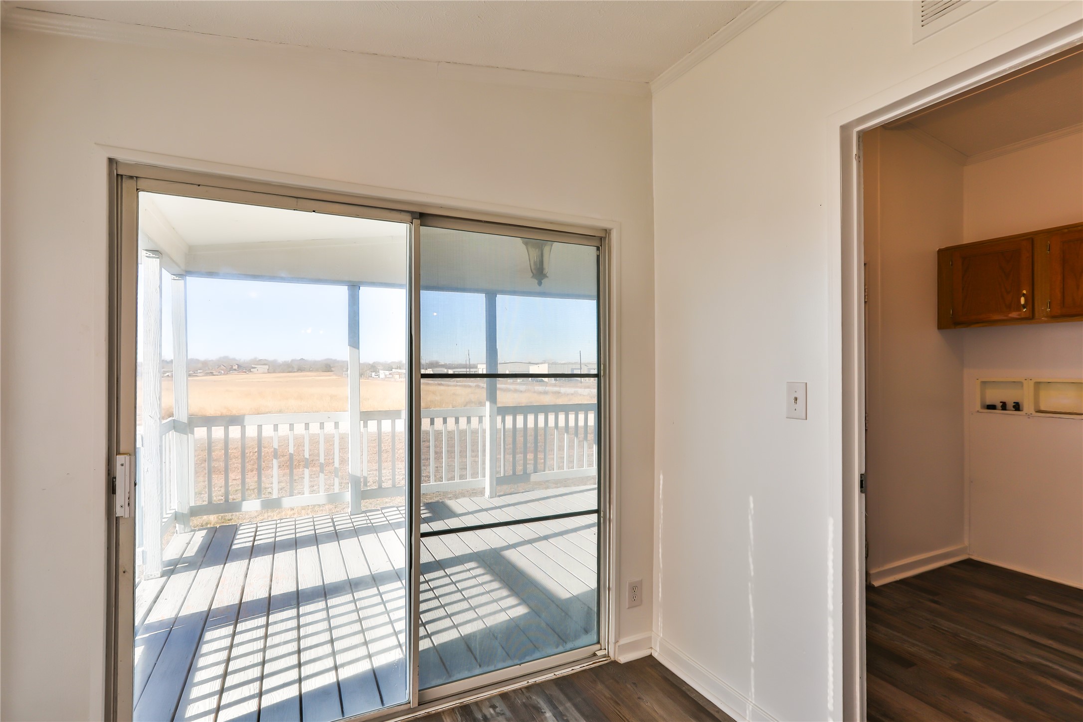 172 Kid Ranch Lane San Marcos, TX 78666 - Photo 7 of 29 Doorway to outside featuring wood finished floors and crown molding