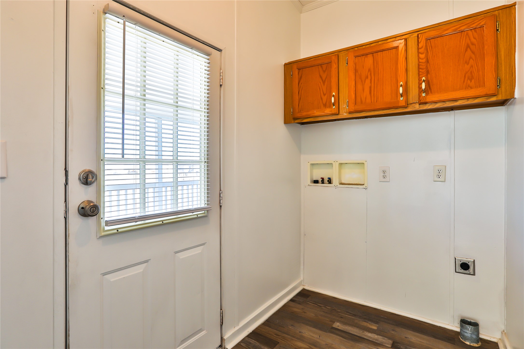 172 Kid Ranch Lane San Marcos, TX 78666 - Photo 8 of 29 Laundry area with electric dryer hookup, dark wood finished floors, hookup for a washing machine, and cabinet space