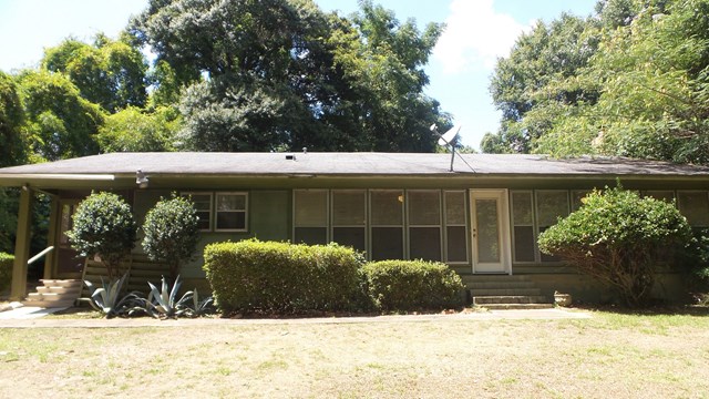 3585 Forrest Road Columbus, GA 31907 - Photo 1 of 21 a view of a house with a yard covered in snow
