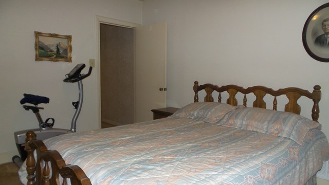 3585 Forrest Road Columbus, GA 31907 - Photo 13 of 21 a bedroom with a bed and a chandelier