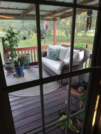a view of a living room and floor to ceiling window