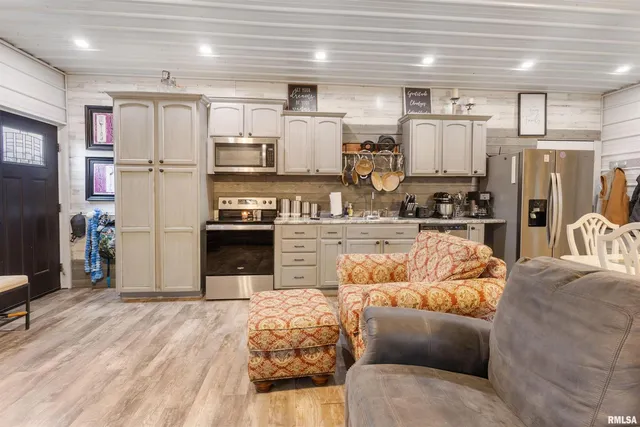 a kitchen with stainless steel appliances granite countertop a refrigerator a stove and a sink