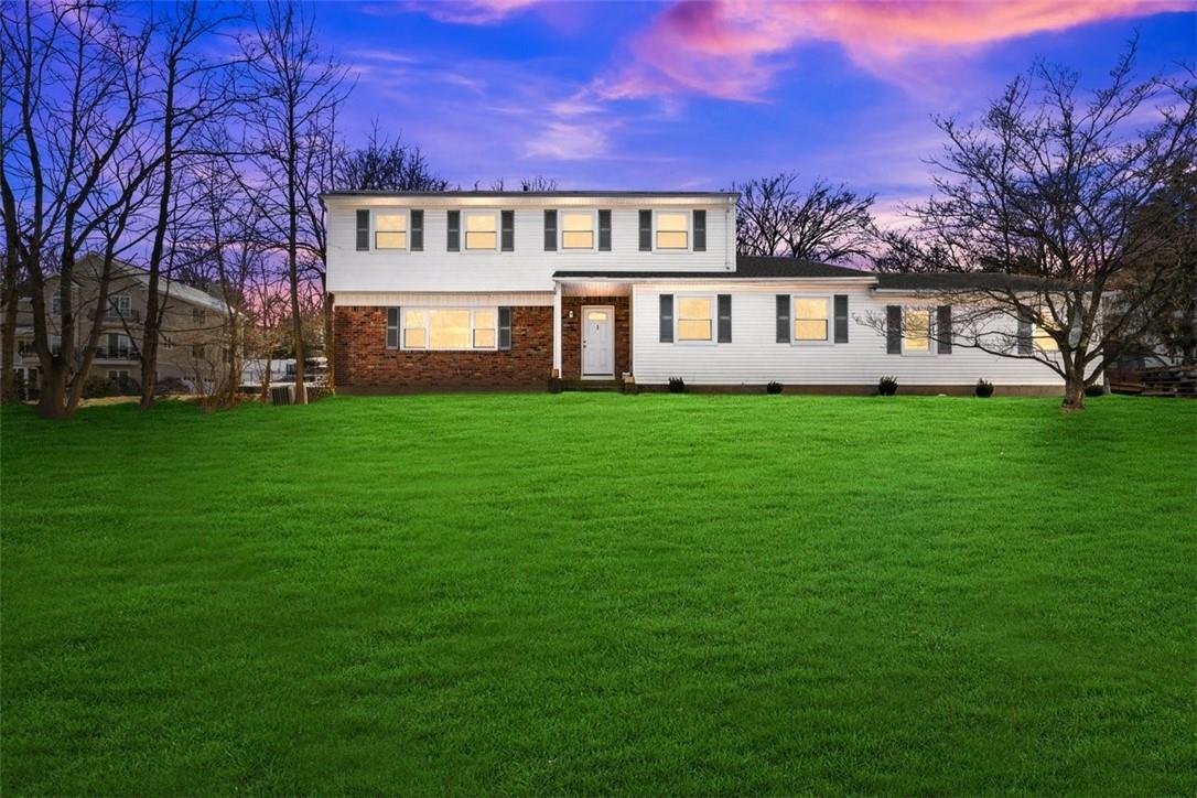 a view of a house with a yard