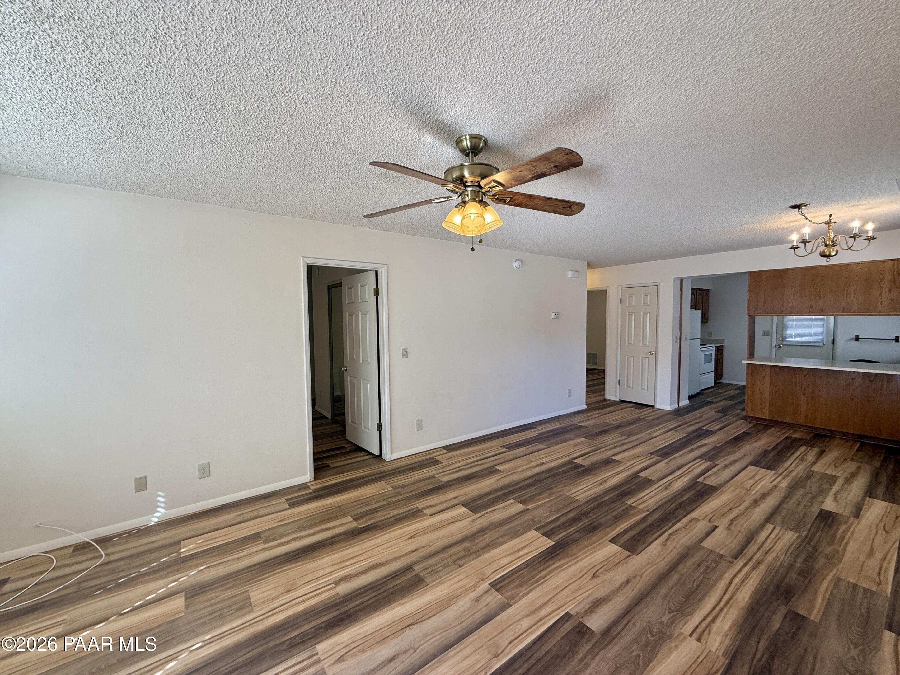 350 Rim Rock Circle, Unit 2 Prescott, AZ 86303 - Photo 5 of 14 a view of a bedroom with a bed and a chandelier