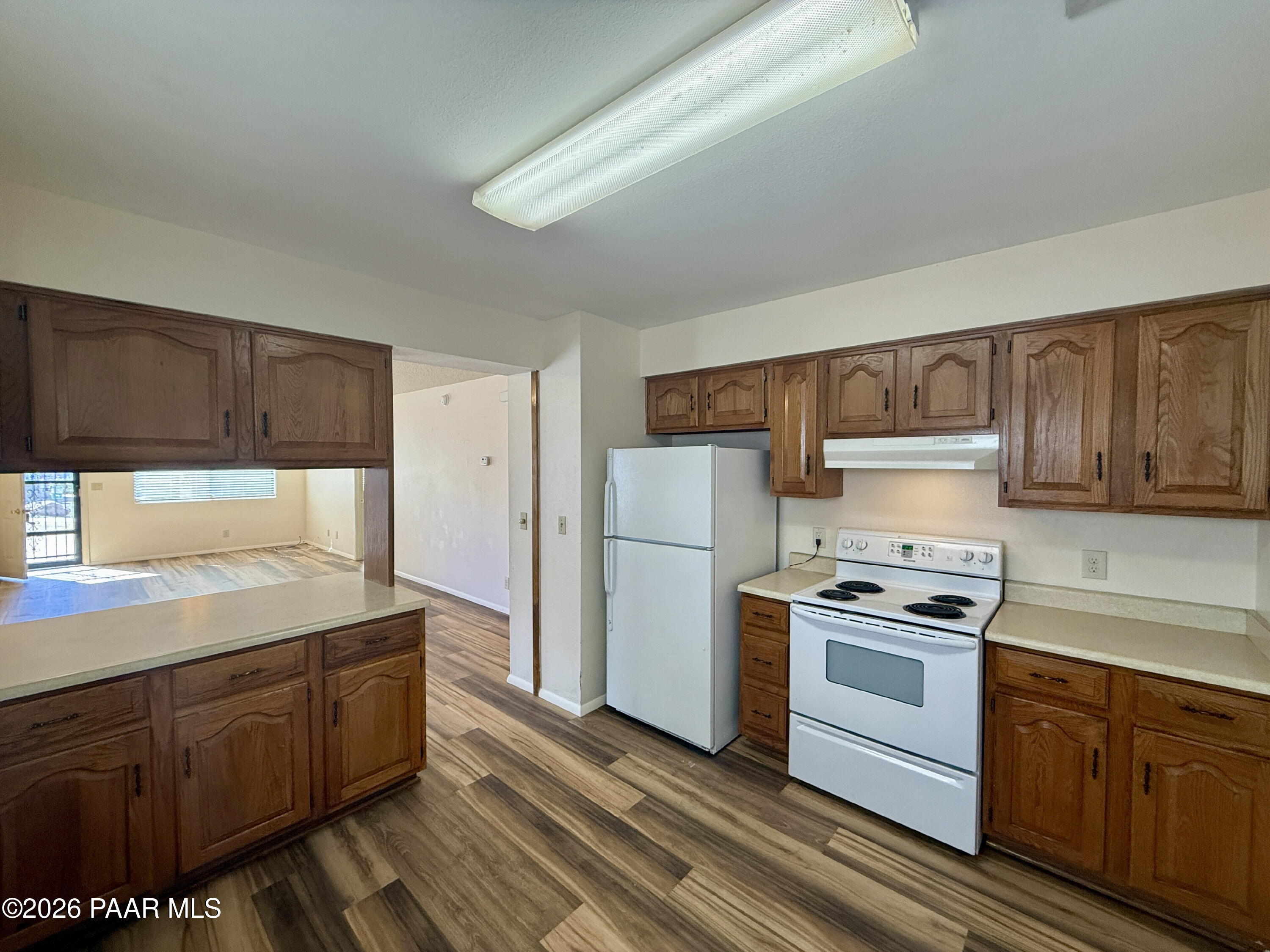 350 Rim Rock Circle, Unit 2 Prescott, AZ 86303 - Photo 8 of 14 a kitchen with wooden cabinets and white appliances