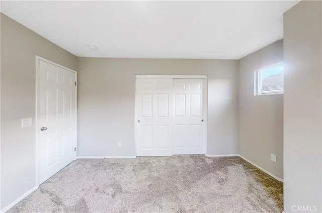 a view of an empty room and closet area