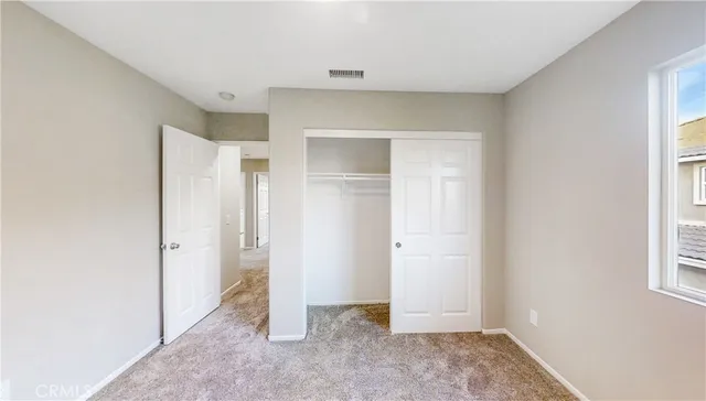 a bedroom with a sink and mirror