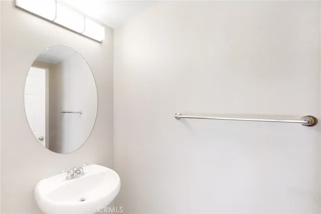 a bathroom with a sink a mirror and a shower